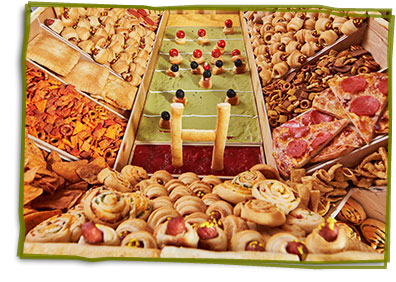 Close up of the inside of the snackadium with pinwheels, pizza slices, crescent dogs and chex mix