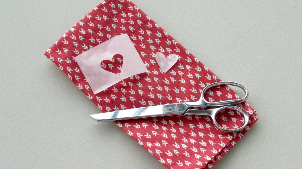 Cut out a 1-inch heart from either a paper towel or a small piece of parchment paper.