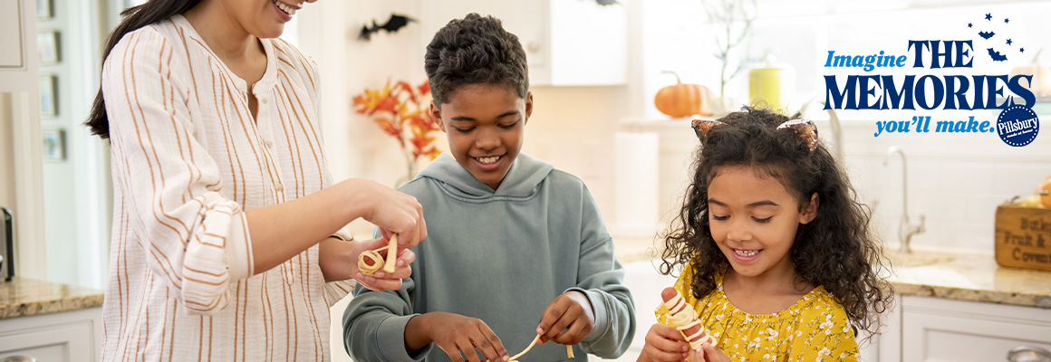 Imagine The Memories You'll Make - Family in the kitchen making mummy dogs