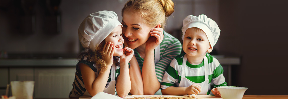 Mom, son, daughter in the kitchen with chef's hats