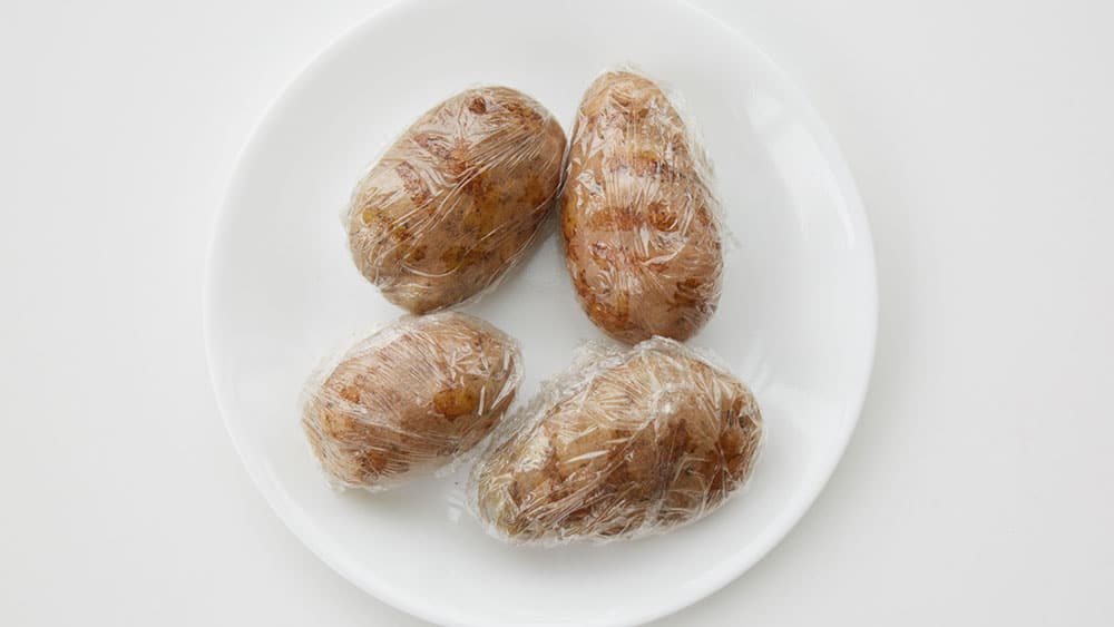Potatoes wrapped in plastic wrap