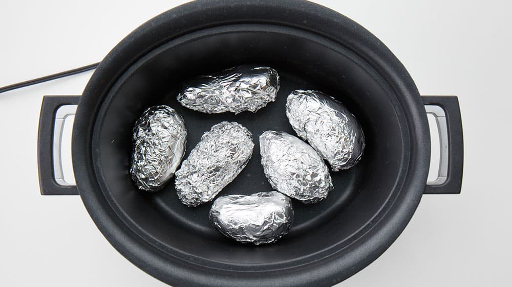 Potatoes, wrapped in tin foil, in a crock pot