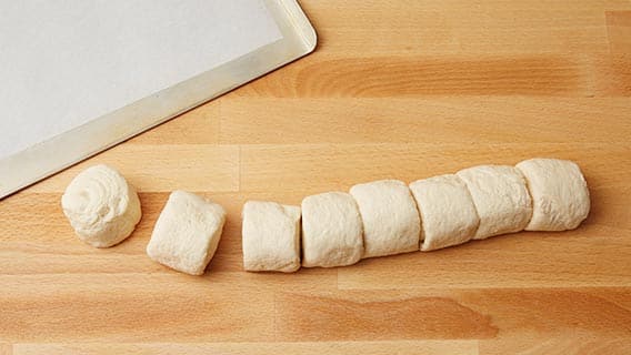 French loaf dough sliced into rolls
