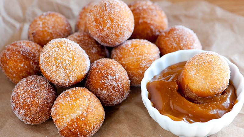 Sugared doughnut holes and caramel sauce
