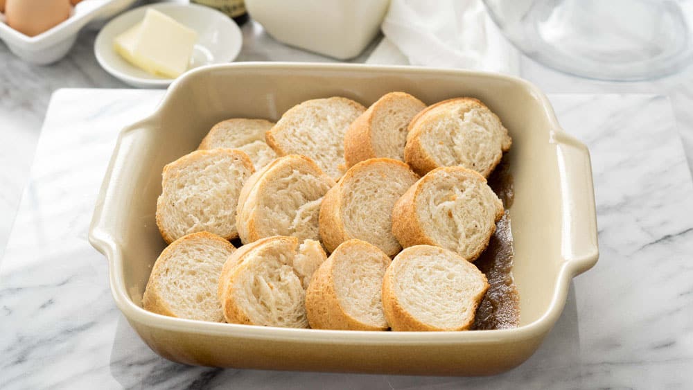 Layer sliced bread in a casserole dish
