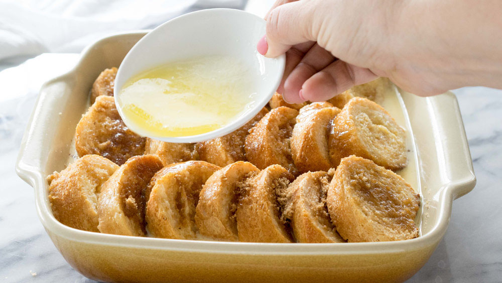 Drizzle melted butter over the top of the bread.