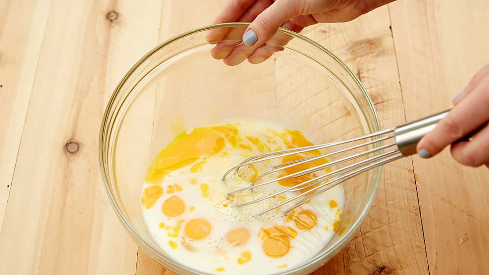 Combine eggs, milk and salt with a wire whisk