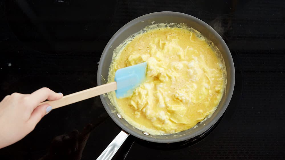 Stir eggs with a spatula