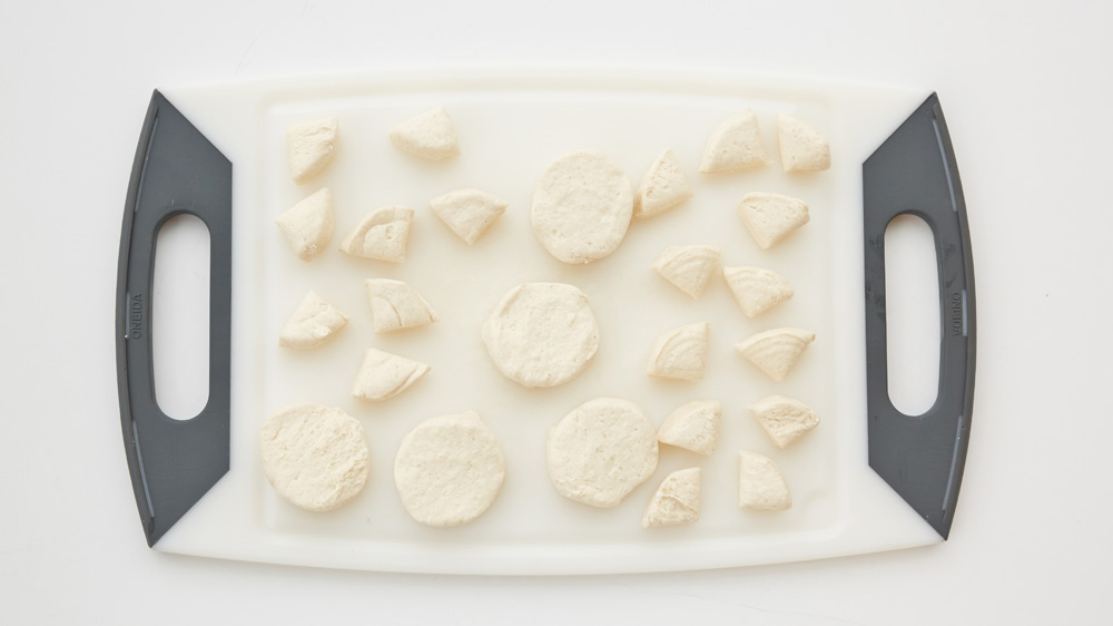 Separate the biscuit dough into 10 biscuits; cut each biscuit into quarters.