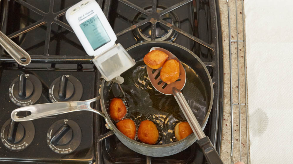 Fry the biscuit quarters, in batches, in the hot oil for 2 to 3 minutes or until golden brown.