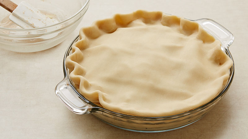 Top with second crust. Wrap excess top crust under bottom crust edge, pressing edges together to seal; flute. 