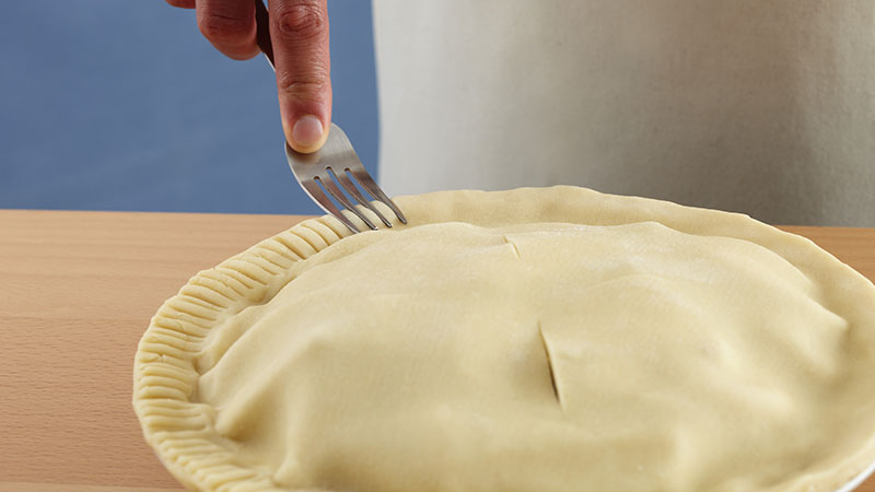 Dip a fork tine in flour, then press the fork into the crust edge, facing inward, without pressing through the pastry. 