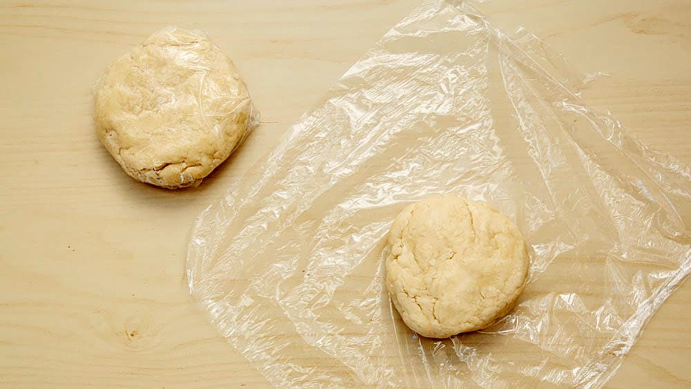 Shape dough into 2 balls. Flatten each gently into a disc shape, wrap in plastic wrap.