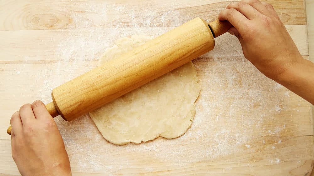 Roll 1 ball of dough lightly from center to edge into an 11-inch circle.