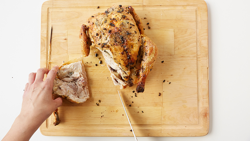 While pulling leg away from body, cut to separate the drumstick from the breast. 