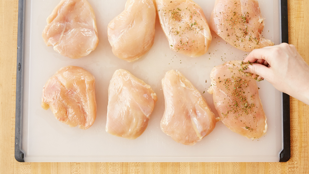 Sprinkle chicken breasts with seasonings