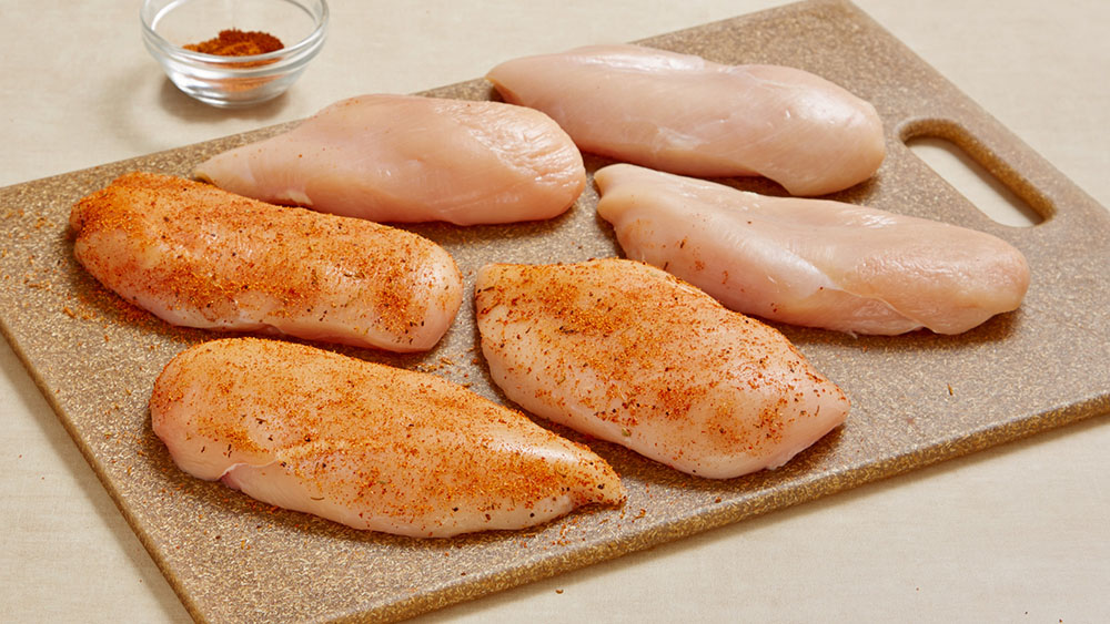 Rub Cajun seasoning on both sides of chicken.