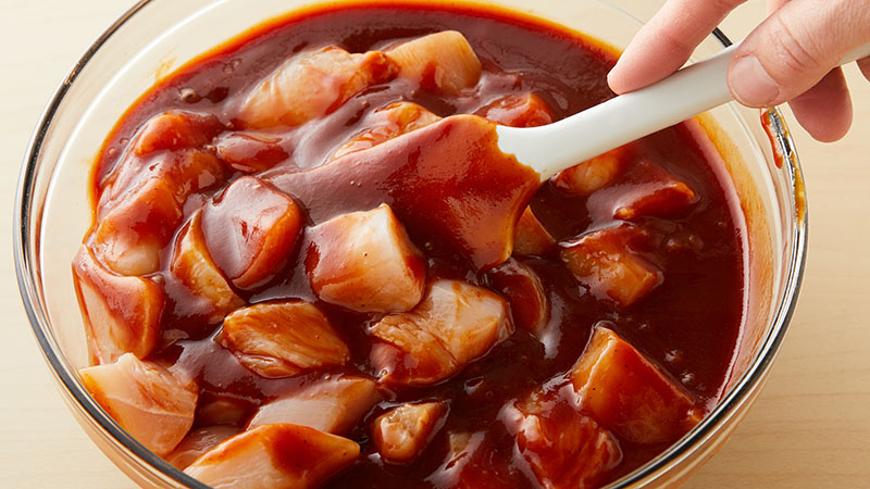 Cubed chicken and bbq sauce in a bowl