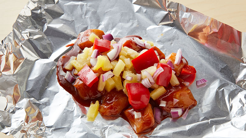 Chicken, pineapple, peppers on a piece of foil