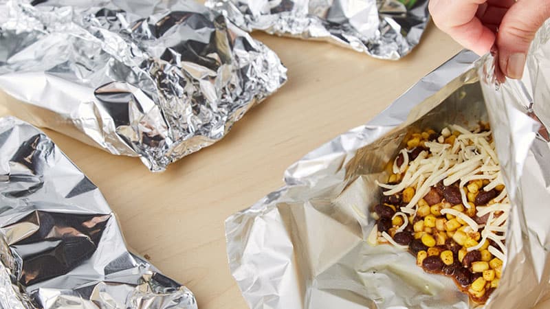 Bring up two longer sides of one piece of foil so the edges meet. 