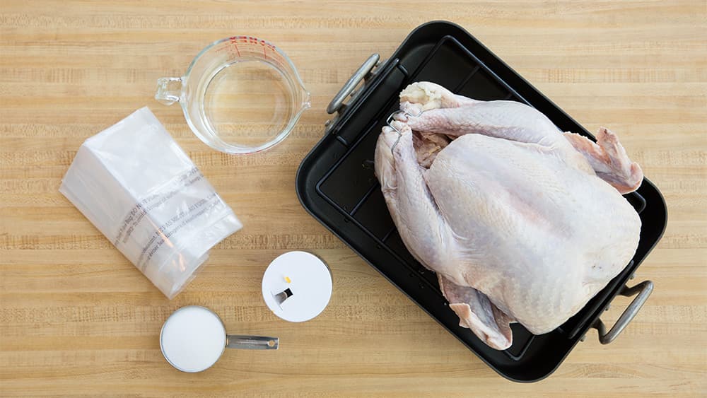 Turkey, brining bag, salt, measuring cups, roasting pan
