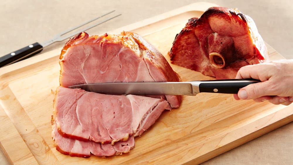 Slicing ham on a cutting board
