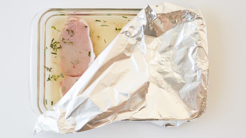 Place pork chops in brine and cover