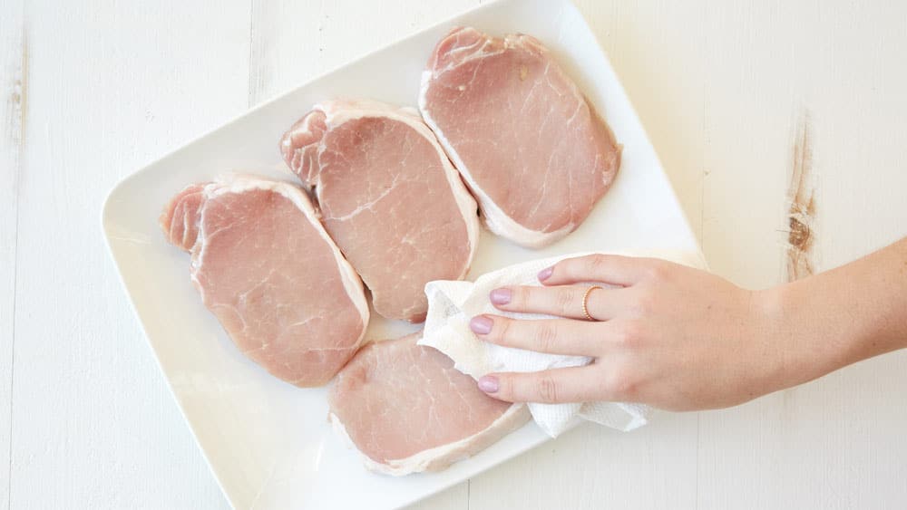 Remove the pork chops from the brine and pat them dry with a paper towel. 