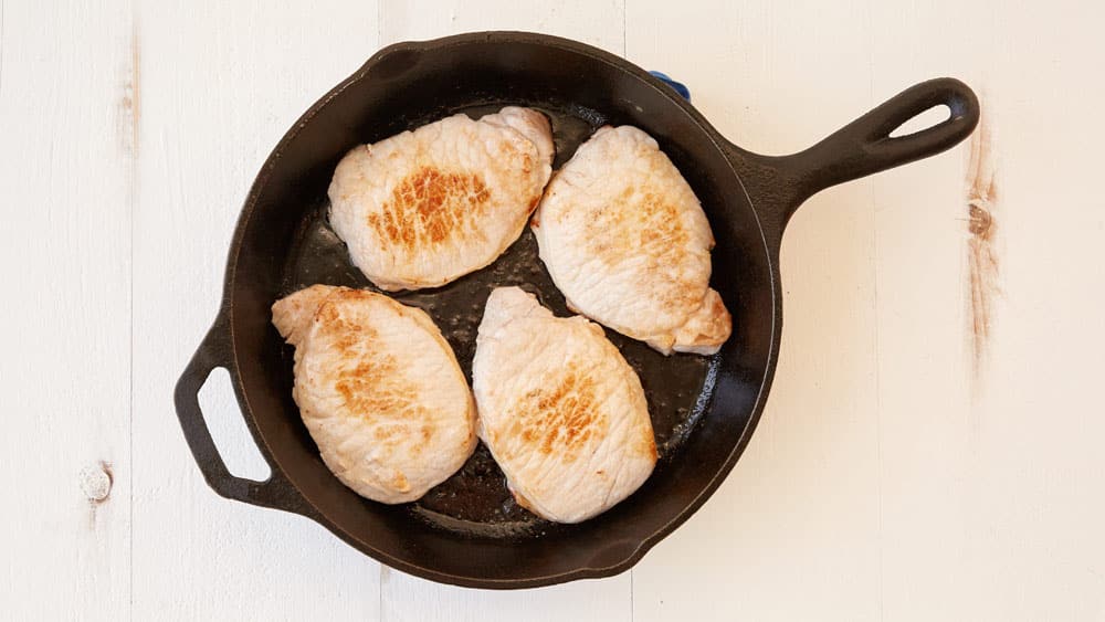 Brown pork chops in a skillet