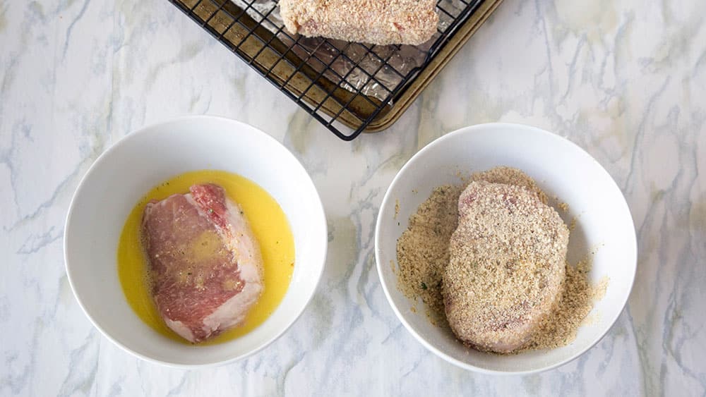 Dip pork chops into egg mixture, then into breadcrumb mixture, turning to evenly coat. 