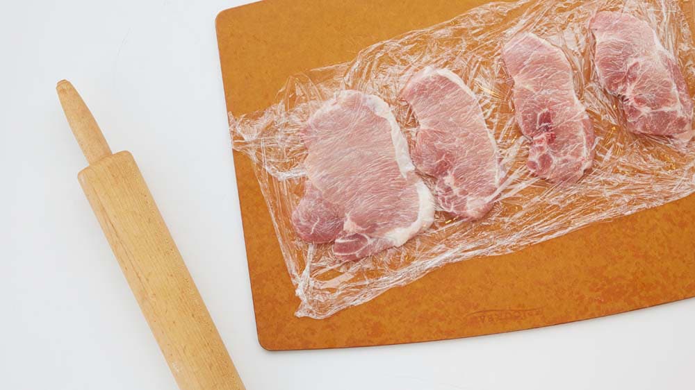 Flatten pork chops between 2 pieces of plastic wrap or waxed paper
