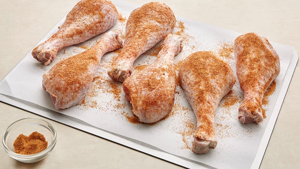 Seasoned turkey legs on a cutting board