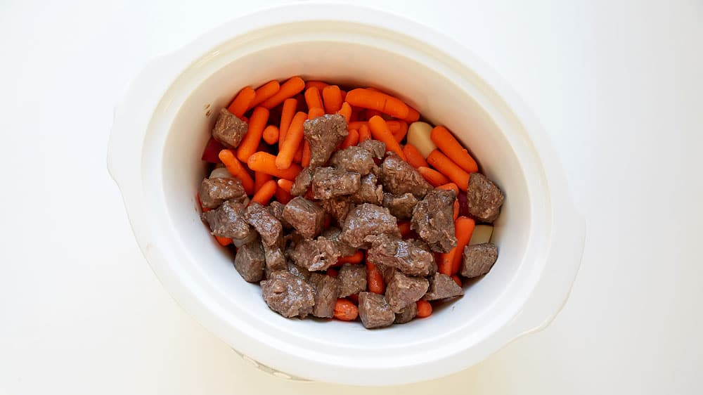 Layer, beef, carrots and onions in a slow cooker