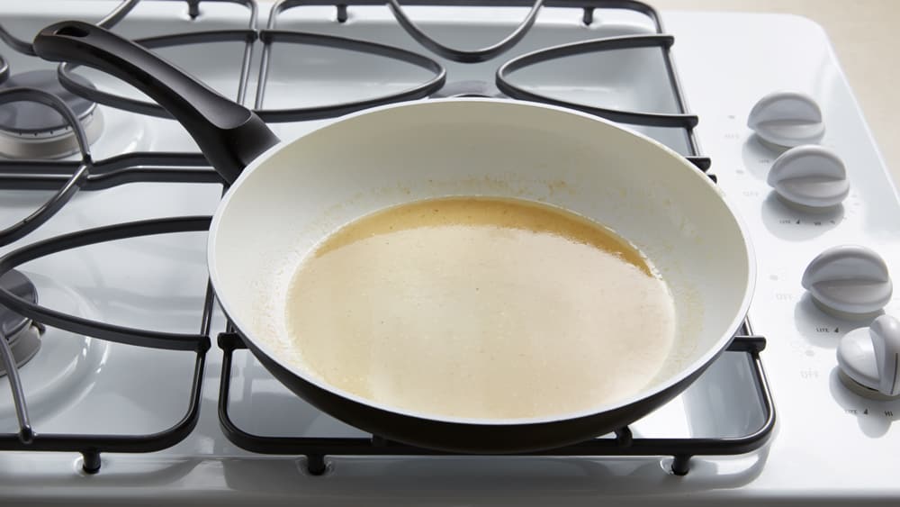 Turkey drippings in a skillet on the stove top