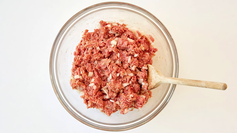 Mix together ground beef and chopped onions