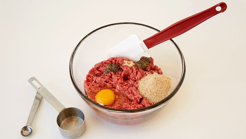 Combine ground beef, egg, breadcrumbs, spices in a mixing bowl