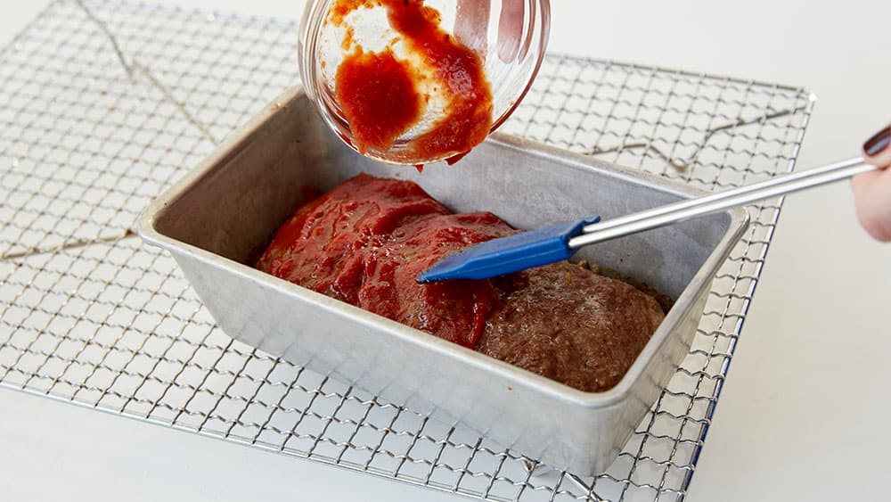 Top baked meatloaf with ketchup