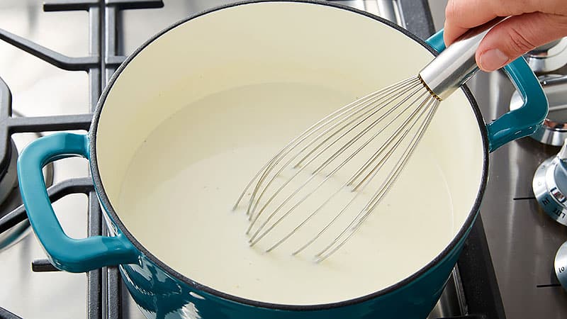 Whisk together the milk and the flour in the Dutch oven.