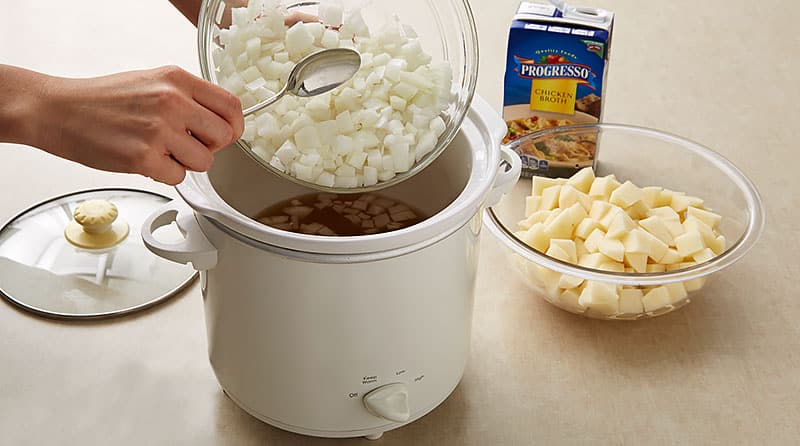 In the slow cooker, mix chopped onions, diced potatoes and broth.