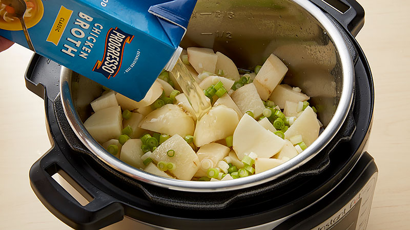 Stir in the potatoes, green onion whites, salt and broth into bacon drippings in the insert. 