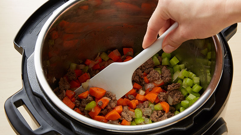 Combine, ground beef, chopped carrots, chopped celery in the Instant Pot