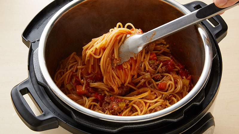 Use tongs to stir the mixture