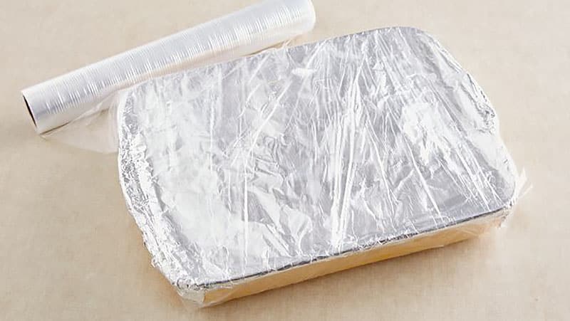 Baking pan wrapped in tin foil and plastic wrap
