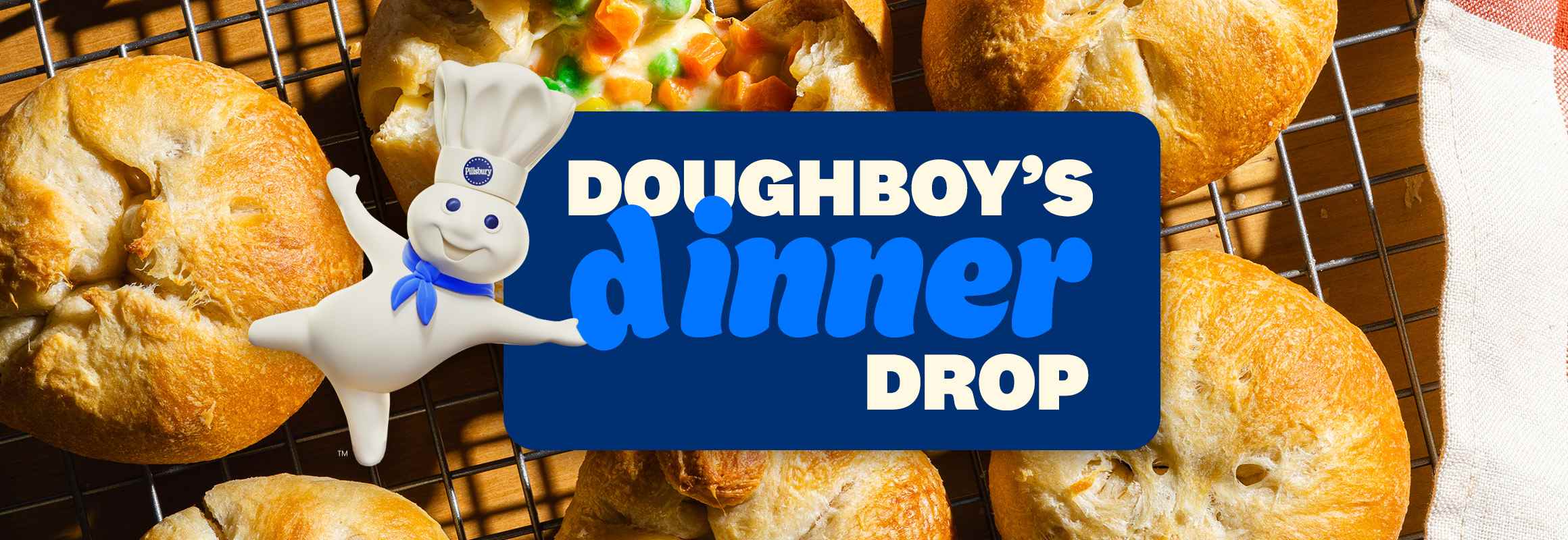The Doughboy is presenting a dark blue sign with text that says 