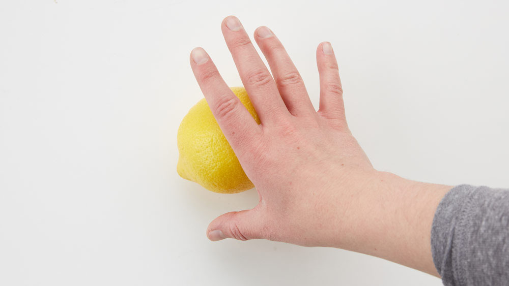 Roll lemon with the palm of your hand 