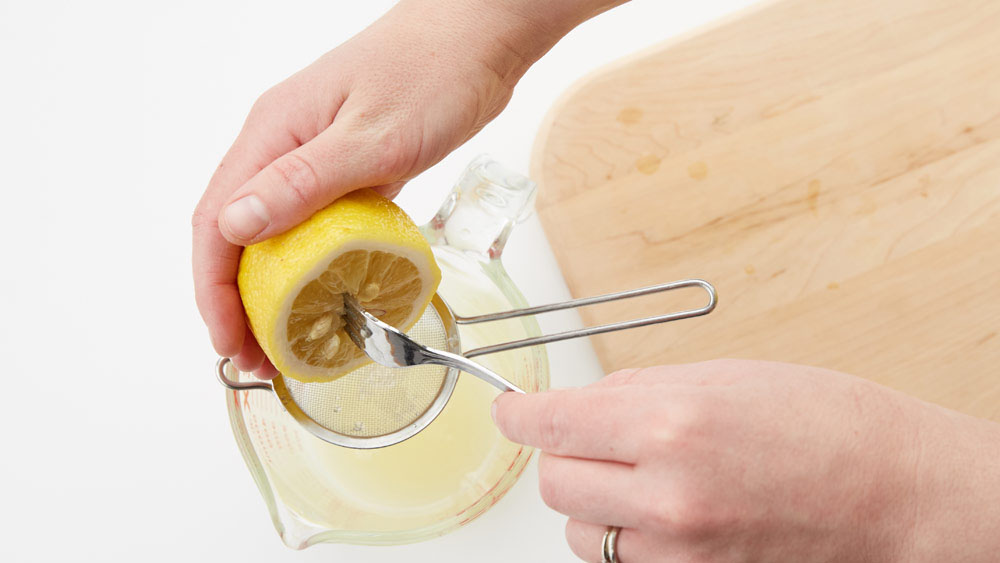 Use a fork to squeeze the lemon