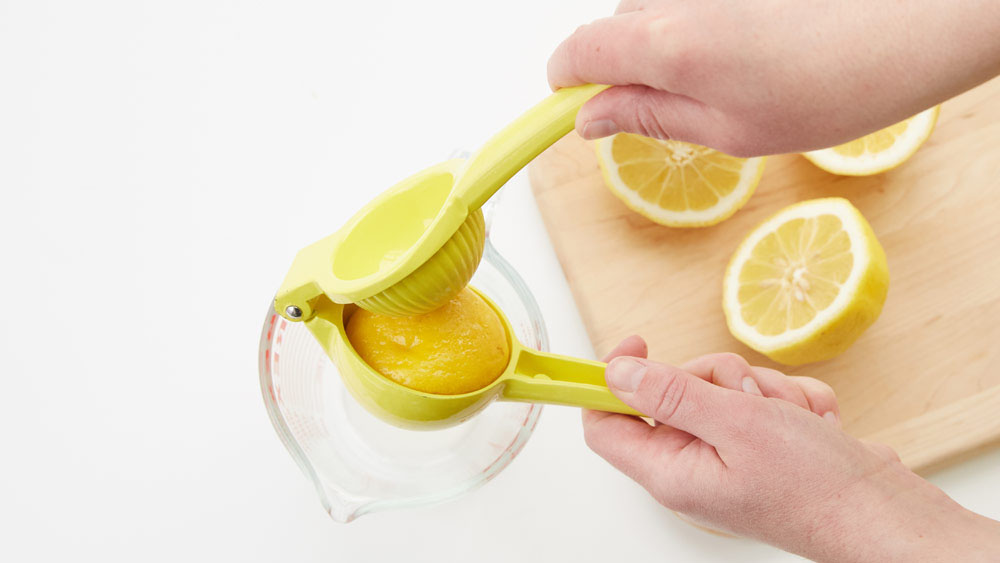 Use a citrus press to juice a lemon