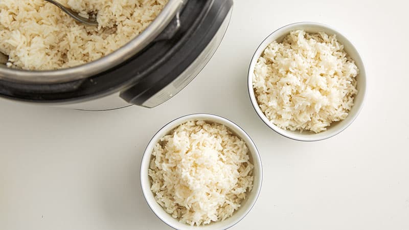 White rice in an Instant Pot and 2 bowls of rice