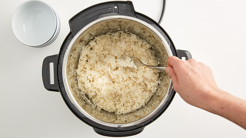 Stir white rice in an Instant Pot