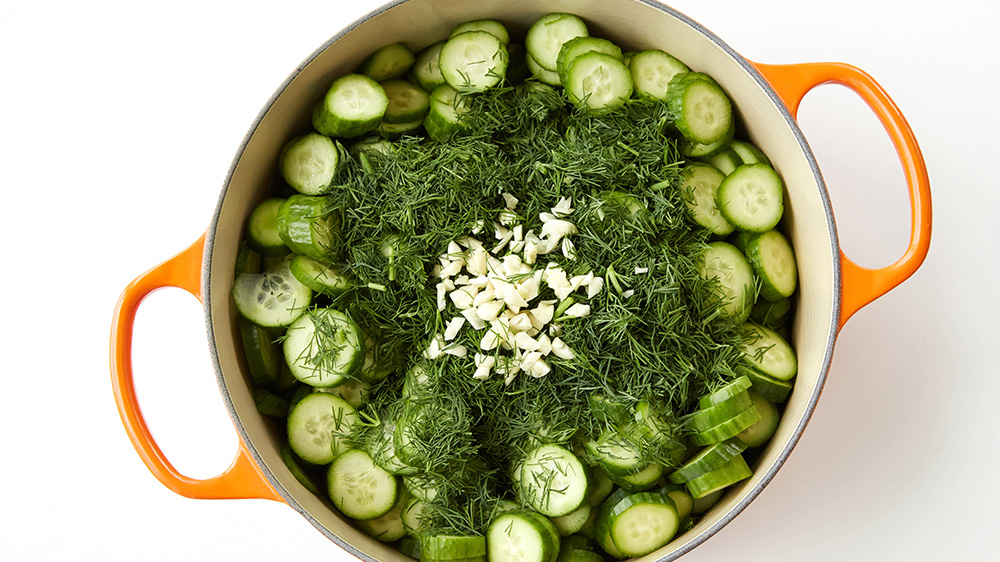 Sliced cucumbers, dill, garlic in a pot